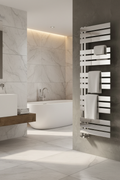 Reina Ricadi polished stainless steel designer heated towel rail in a luxury marble bathroom setting